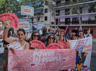 Thousands of activists take to the streets demanding urgent debt cancellation ahead of global summit