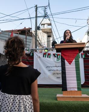 The Rise of Palestinian Women's Leadership in Refugee Camps, Shatha’s speaking at a Bazaar