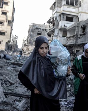 Palestinian women and children carrying belongings flee to safer areas following Israeli bombardments on southern part of Gaza City