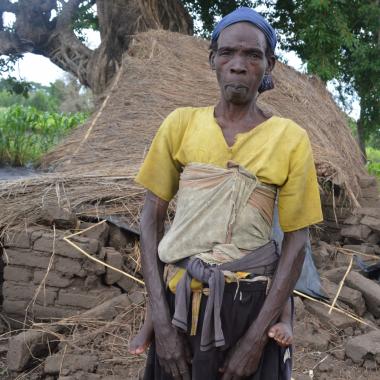 Emery Kachingwe standing in front of what used to be her house