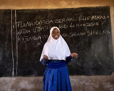 Teresia standing at the front of the class