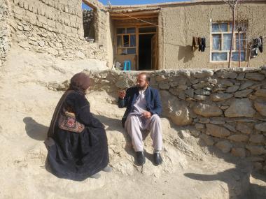 A member of the ActionAid Afghanistan team speaks to Sara after a distribution of cash and hygiene kits.
