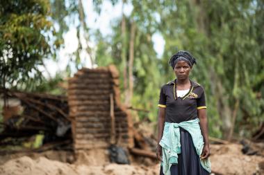 Asiya walking through the debris created by Cyclone Freddy