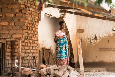 Anne stands in her destroyed home, in Phalombe southern Malawi.